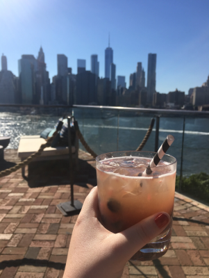 Kelly Meehan Brown enjoys a drink on a rooftop bar ("Independent Contractor Taxes, Rooftop Bars, and the True Meaning of Broke")
