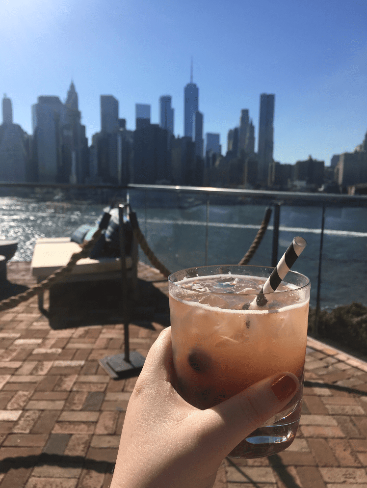 Kelly Meehan Brown enjoys a drink on a rooftop bar ("Independent Contractor Taxes, Rooftop Bars, and the True Meaning of Broke")
