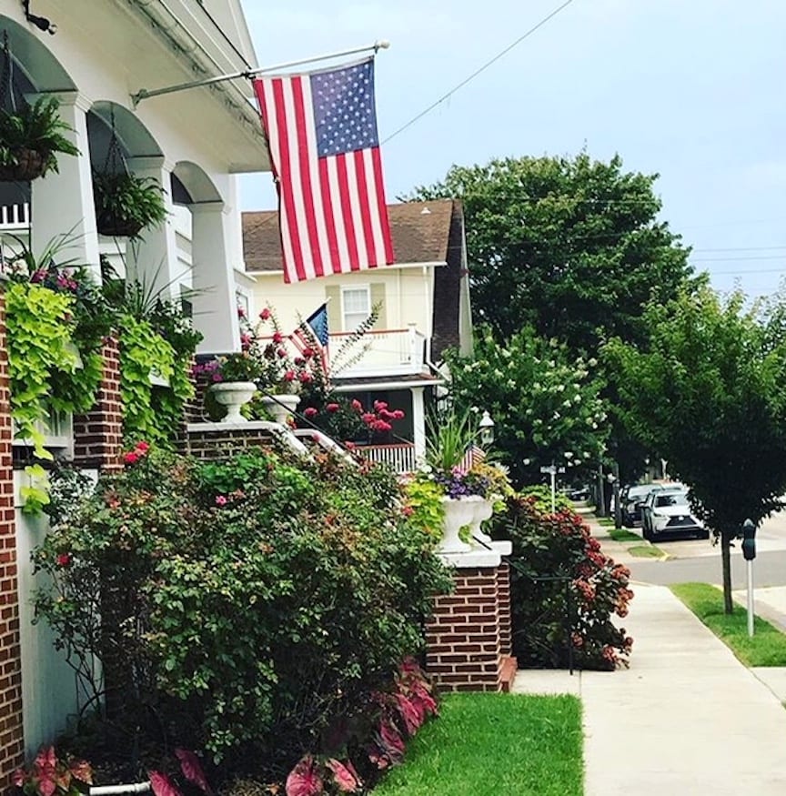 When and How to Work From Home: Amazon work-from-home jobs | Photo of a suburban house with an American flag | Photo by Rita Pouppirt
