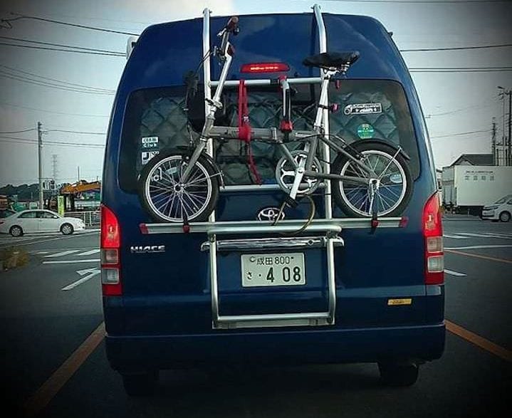 Leasing vs. Buying a Car: What’s the Best Choice for You? | Photo of a car with a bike strapped to the back | Photo by Daye Deura