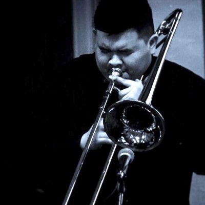 How to Start a Record Label: A ‘Clever’ Story | Photo of Justin Schmitt, co-founder of Clever Records, playing the trombone
