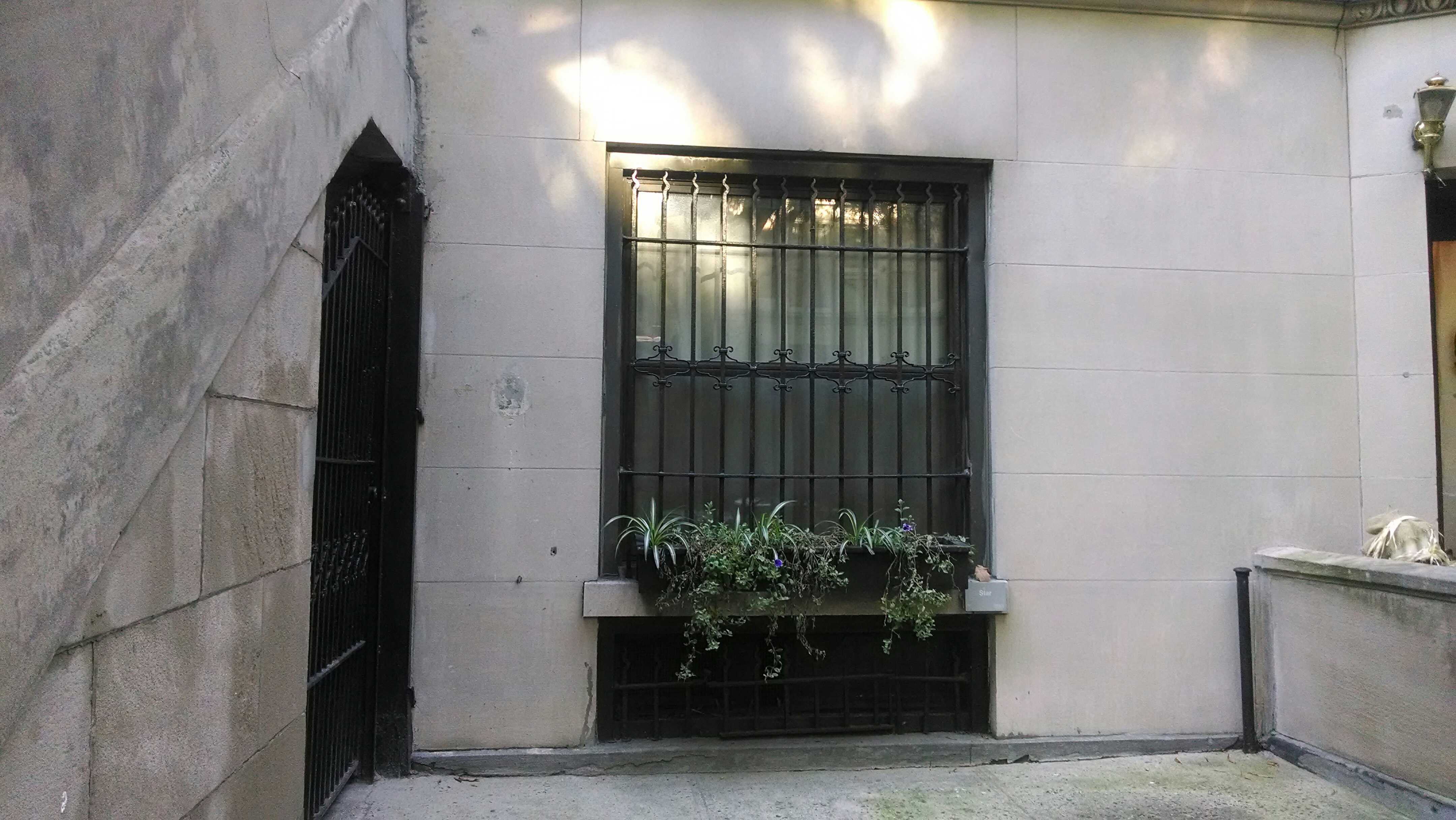 What is a mortgage? How does a mortgage work? | Photo of a white stone townhouse with a flowerbox in the window | Photo by Evan Sachs