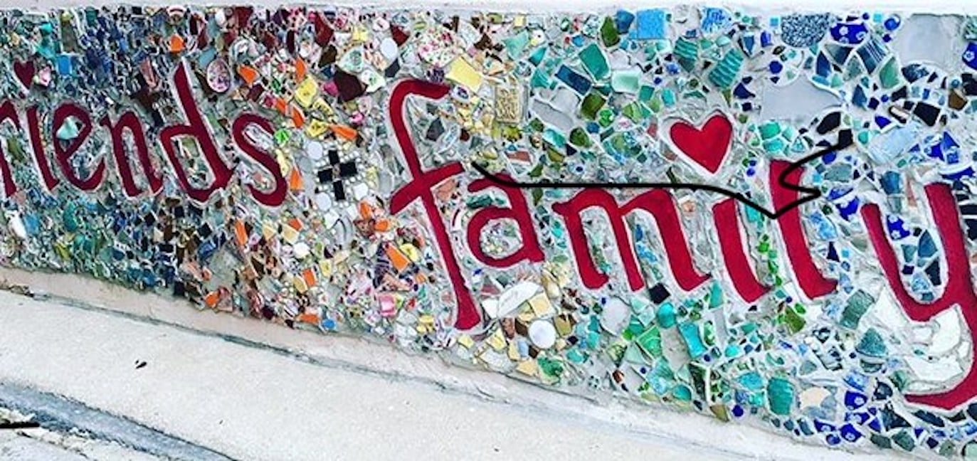 What is wealth? What does wealthy mean, really? | mural that reads "friends & family" | Photo by Rita Pouppirt